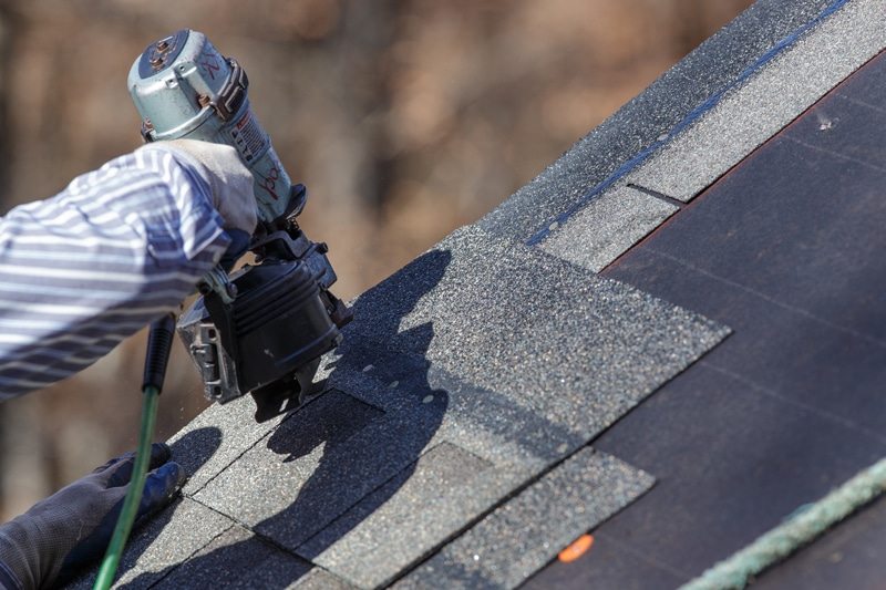 Nailing shingles to a roof of a home