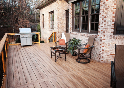 Chestnut colored decking attached to a brick house