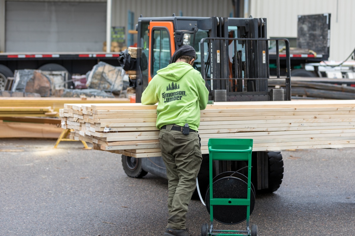 Man Loading Wood On A Forklift